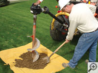 Auguring a hole in the earth for a foundation repair in Lander