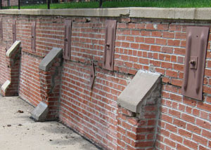 Rusted wall plate anchors in a retaining wall repair in Manville.