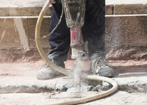 Jackhammering a slab floor in a Evanston home.