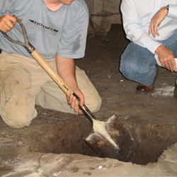 Digging a hole for the engineered fill used in a crawl space support system installation in Green River