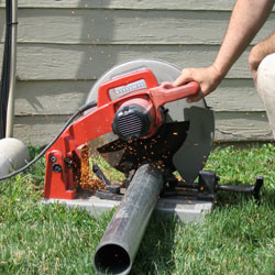 Cutting the support beam for a crawl space jack post outside a Riverton home.