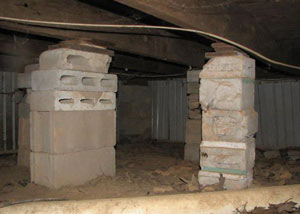 crawl space repairs done with concrete cinder blocks and wood shims in a Worland home