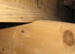 A failing girder showing signs of compression damage in a Wyoming home