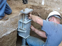 Foundation repair contractors installing the foundation bracket in Gillette.
