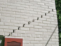 Stair-step cracks showing in a home foundation in Newcastle