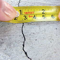 A crack in a poured concrete wall that's showing a normal crack during curing in Clearmont