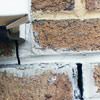 Failed crack repair showing old tuckpointing that cracked on a Gillette home.