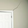 A long drywall crack beginning at the corner of a doorway in a Mills home.