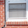 A gap in a window along the outer wall due to foundation settlement of a Torrington home.