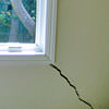 A long, diagonal crack that begins at a window corner of a Buffalo home