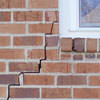 long jagged cracks starting at the corner of a window along a brick wall on a Worland home