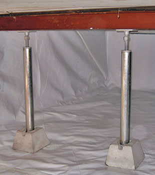 Crawl space jack posts installed in conjunction with a crawl space vapor barrier in Parkman