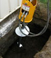 Installing a helical pier during a foundation repair in Laramie