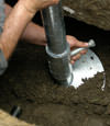Laramie helical pier installation nearing completion, with the blade being advanced into the foundation soils.