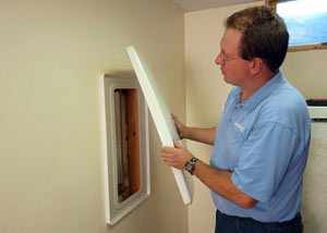 Foundation wall anchor covers installed in a finished basement with a repaired foundation wall in Parkman.