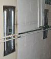 Foundation wall anchor plates installed in a basement in Gillette