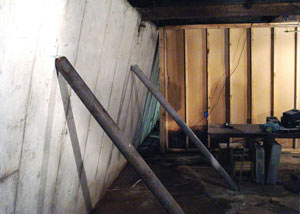 A severely tilting foundation wall propped up by steel beams in Edgerton.