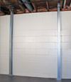 A steel i-beam system installed on a Edgerton foundation wall