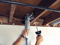 Straightening a foundation wall with the PowerBrace™ i-beam system in a Jackson home.