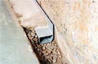 Drain tile being installed on the perimeter