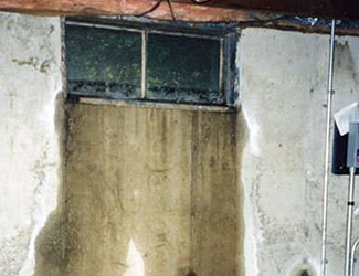 Water pouring out from a basement window in Rock Springs